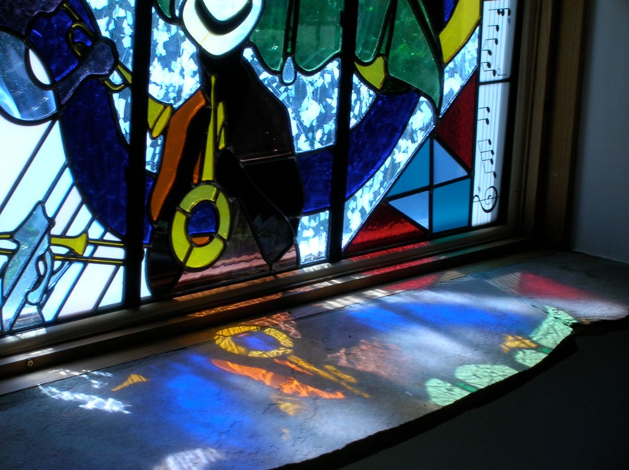 close up of "Nick of Time" Triptych stained glass window with reflections