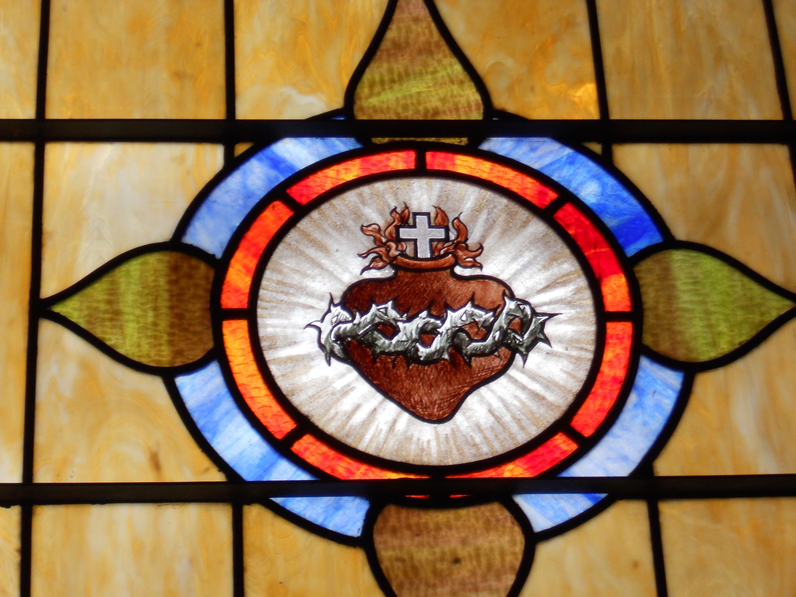 Stained glass painted Sacred Heart close up