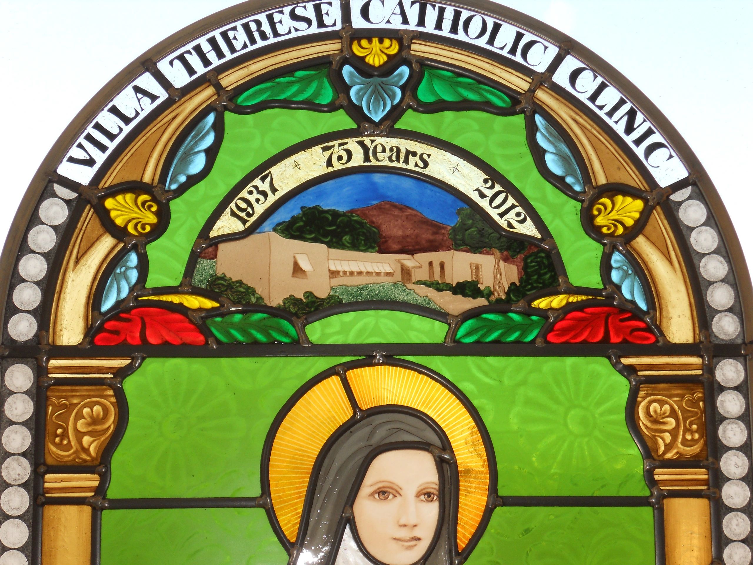 St. Therese , painted stained glass, green painted background.
