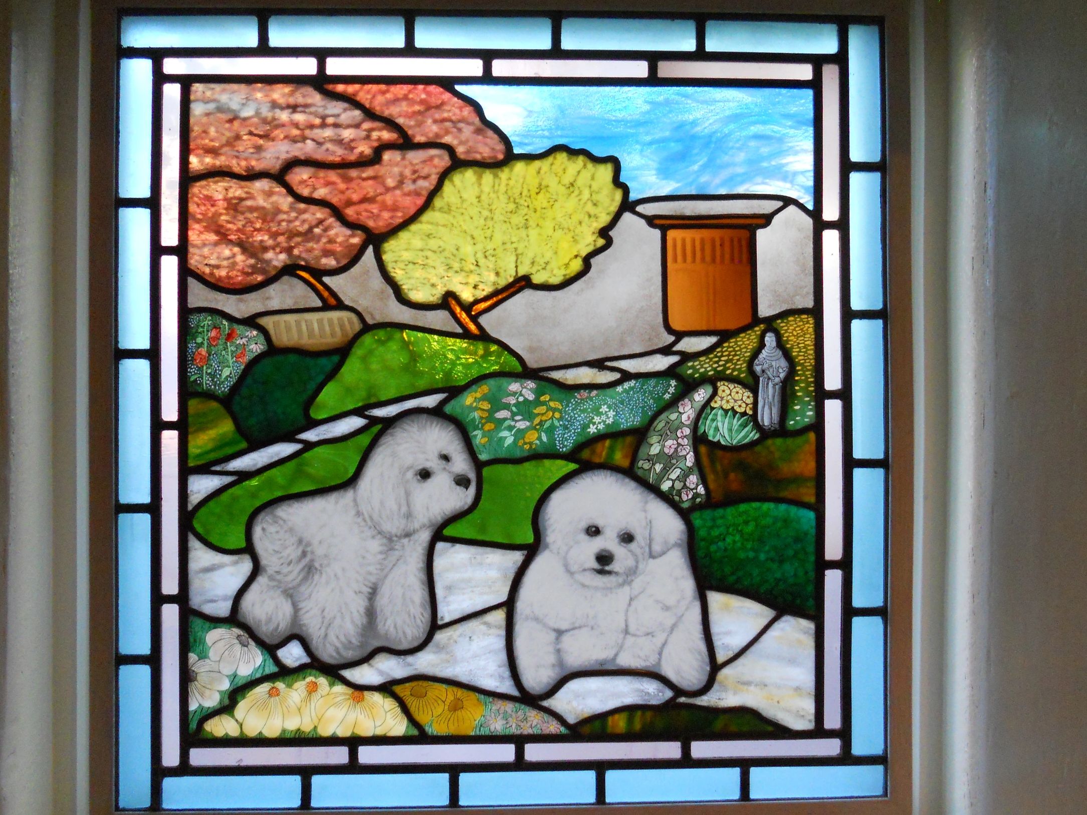 two furry white dogs painted on glass in a backyard setting, greens, yellows, and golds