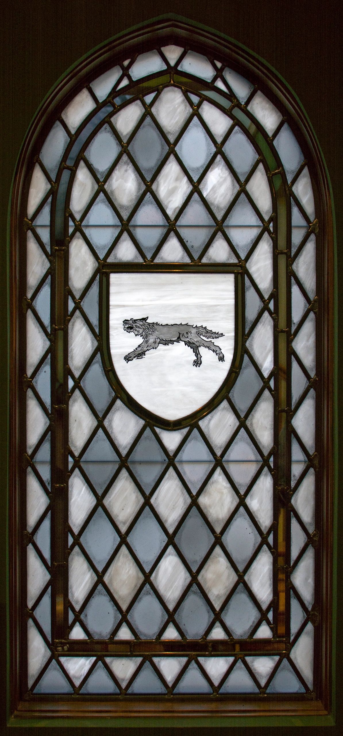 Dire wolf running across a field of snow in center of sigil
