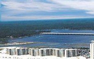 Beachfront resort with high-rise buildings and a pier.