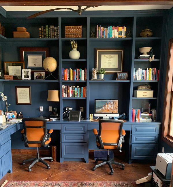 Blue office cabinets with built in desktops.