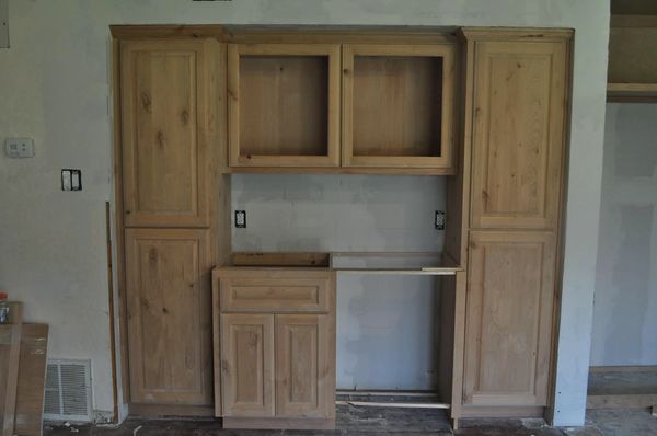 Knotty alder wet bar with raised panel doors and drawer fronts