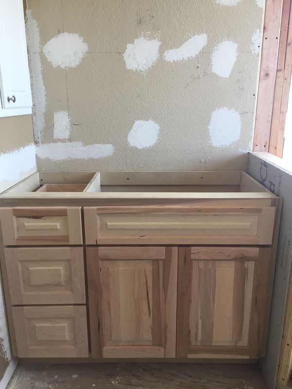 Paint grade vanity cabinet with raised panel doors and drawer fronts