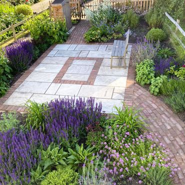 cottage garden with bricks and purple flowers