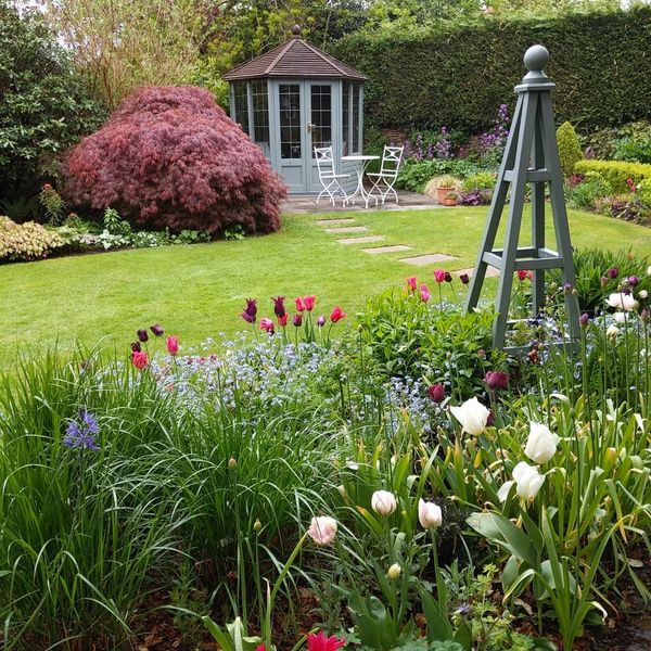 garden with summerhouse and painted obelisk
