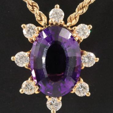 Gold necklace with amethyst and diamond pendant.