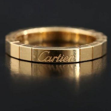 Gold Cartier ring with engraved logo.