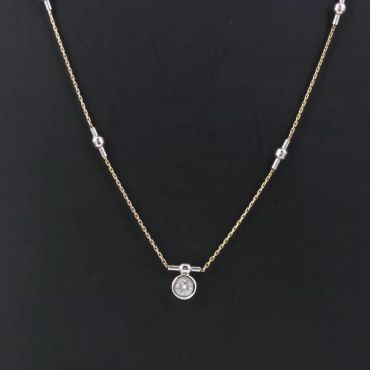 Elegant gold necklace with a round pendant.