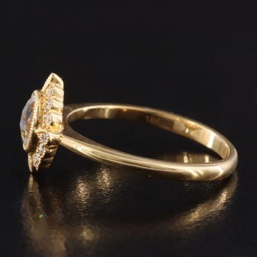 Elegant gold ring with a central diamond.