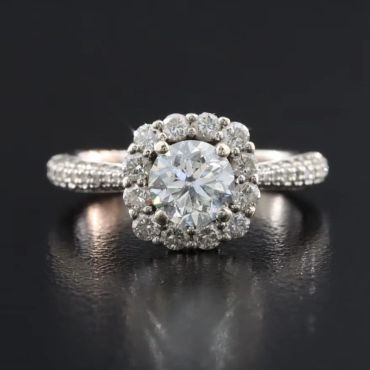 Diamond halo engagement ring with pavé band.