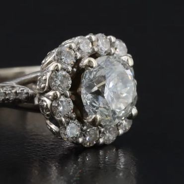 Close-up of a diamond ring with a halo setting.