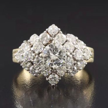 Elegant diamond cluster ring with a central round diamond.