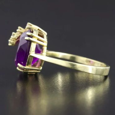 Gold ring with a large purple gemstone.