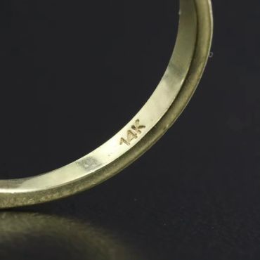 Close-up of a ring stamped with "14K".