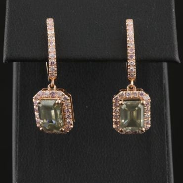 Elegant gold earrings with green gemstones and small diamonds.
