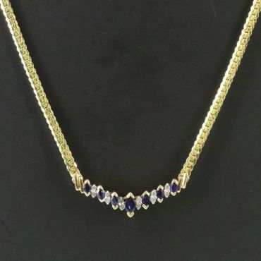 Gold necklace with blue and white stones.