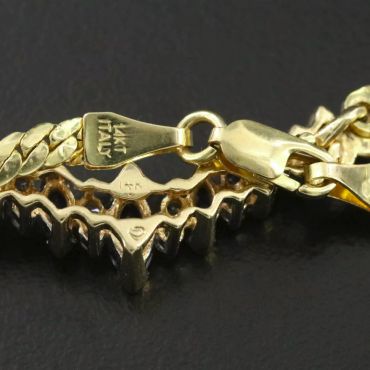 Close-up of a gold necklace clasp with 14KT Italy stamp.