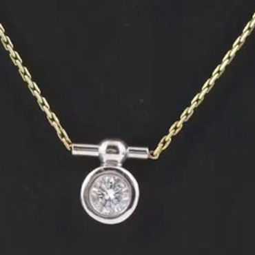 Gold chain necklace with round diamond pendant.