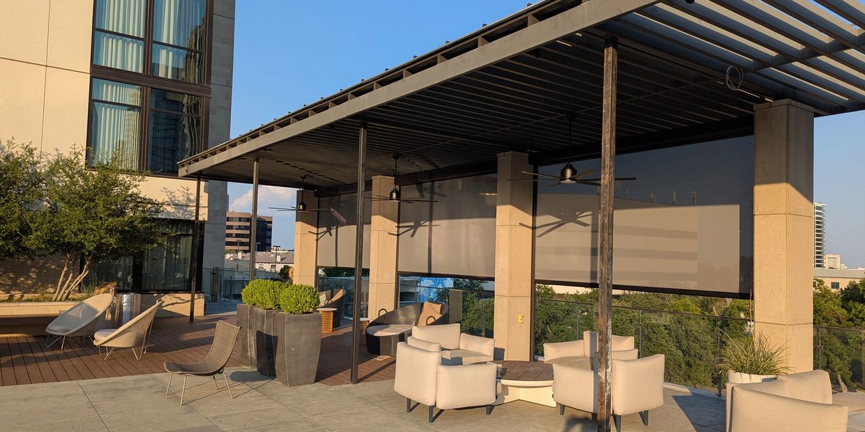 Modern outdoor patio with seating and shade.