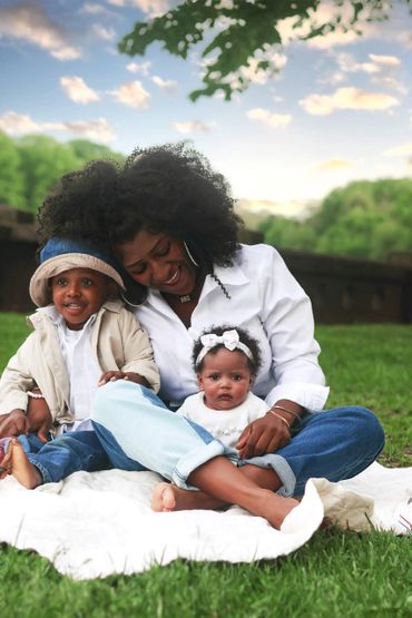 Mom with two young kids in a park