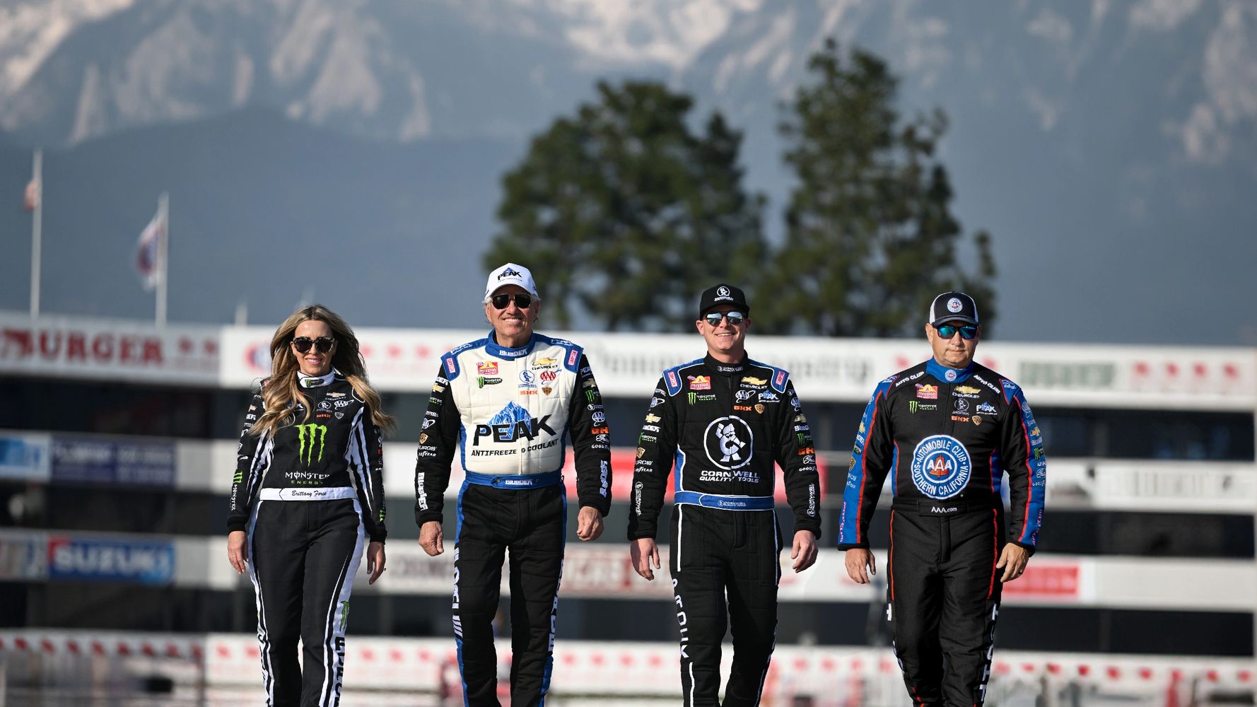 John Force Racing Drivers walking down the race track. L to R: Brittany, John, Austin, and Robert.