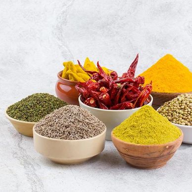 Various Indian spices arranged in bowls.