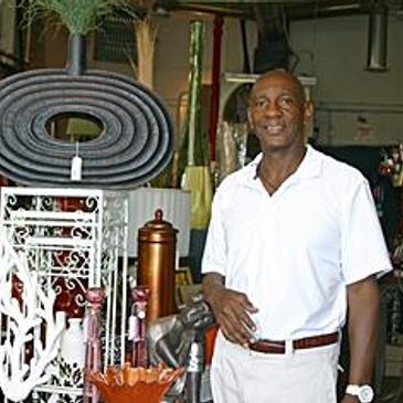 Man in white polo shirt standing in a home decor store.