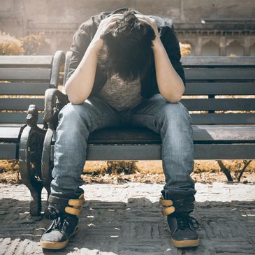 Mental health therapy for suicidal ideation: Taking steps towards improvement. Man on bench.