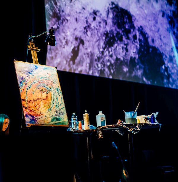 Christian spiritual painting with painting equipment on the table next to it.