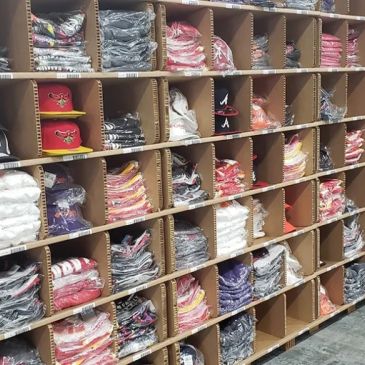 Shelves filled with neatly folded and packed clothing.
