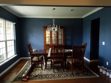 Dining room with wood cabinet painted blue by ipaint in Murfreesboro. Painting company in Symrna