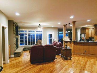 Open concept area painting with rock fireplace and wood floors. Ipaint company murfreesboro