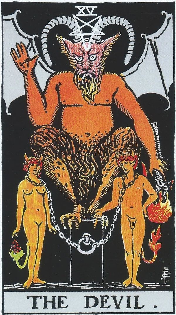 Tarot card The Devil pictured with devil above man and woman tied by chains