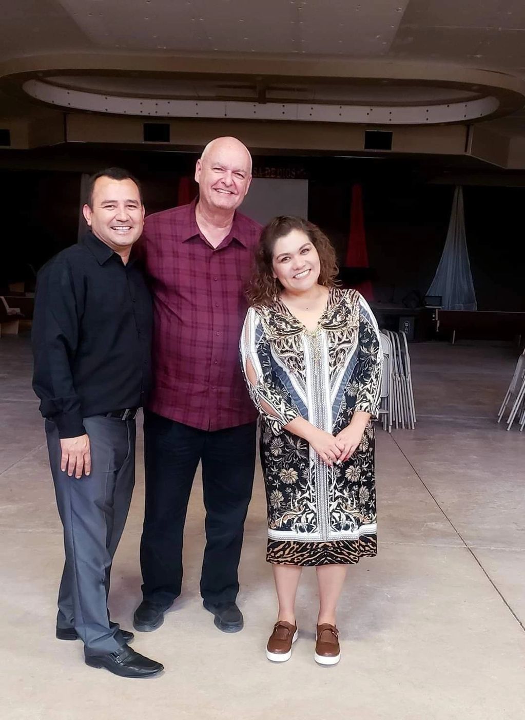 Three people are taking picture