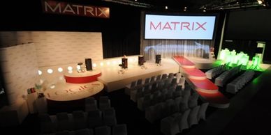 custom stage and set design for trade show conference presentation.  Curved screen projection, stage lighting and sound system