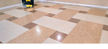Clean tiled floor with a yellow mop bucket in the background.