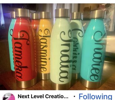 Colorful personalized water bottles with names in elegant script.