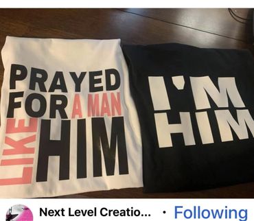 Two folded shirts with bold text messages about love and identity.