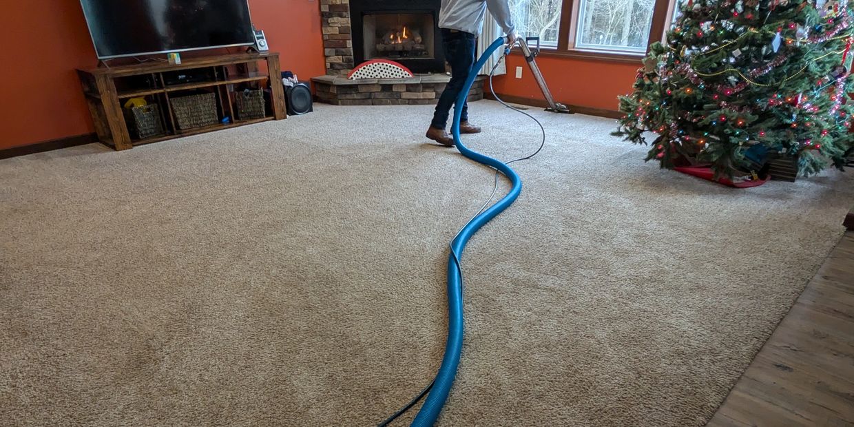 a man with carpet cleaning machine cleaning a carpet
