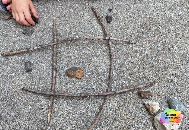 Nature tic-tac-toe with sticks, rocks, and mulch Nature tic-tac-toe with sticks, rocks, and mulch