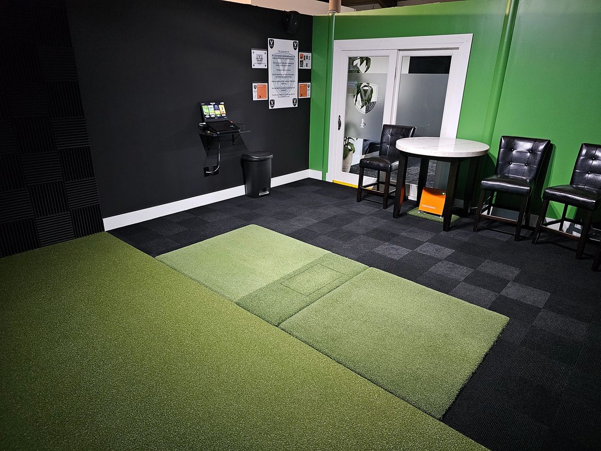 Private indoor golf simulator suite at V Golf
