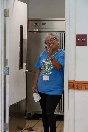 Auntie Monica Powell beautiful smile while she takes a break from kitchen duty at KAYDAY 2019