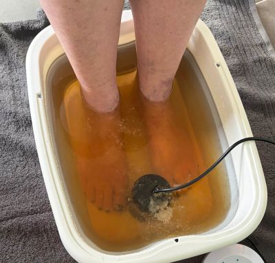 Client enjoying an ionic detox foot spa relaxation treatment at Donna Lee Rix Caboolture