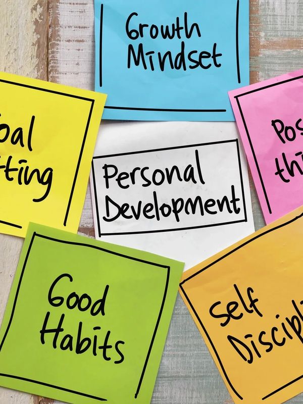 Multiple papers are sticked on a wall and written with text