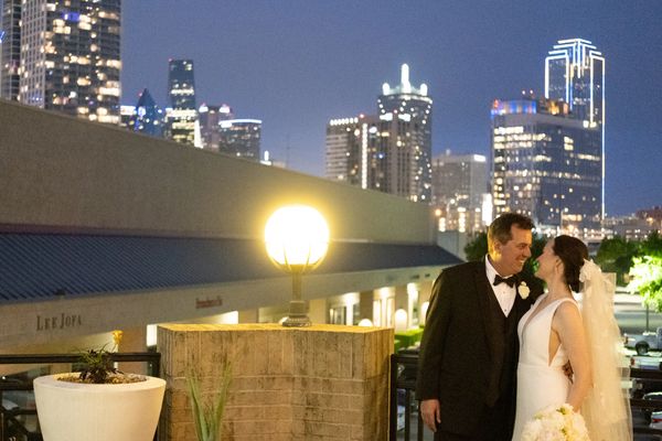 bride and groom with views of downtown da