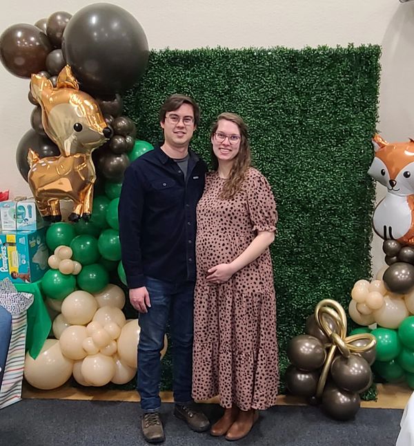 Green Boxwood Backdrop Photo Booth, Woodland Critters Theme with Green, Blush, & Brown Balloons