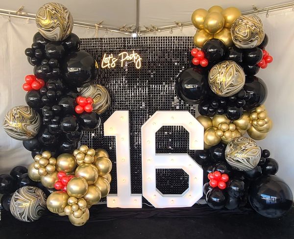 Sweet 16 marquee balloon backdrop, gold, black, and red organic balloon garland, party balloons