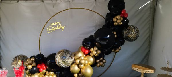 Organic balloon ring with Happy Birthday neon light rental, gold and black balloon garland, birthday